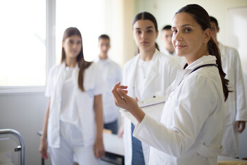 Medical education.  Group of student with professor  in medical center. - 428960310