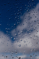 Background. Water drops on the glass, window. Blue sky
