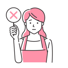 バツを出すエプロン姿の若い女性