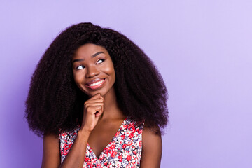 Photo of young afro girl happy positive smile hand touch chin dream think look empty space isolated over purple color background