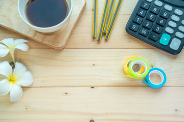 Background concept, Coffee mugs, pencils, stationery and small flowers on the wooden floor, start your work day refreshed.