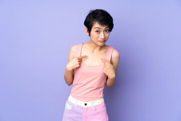 Fototapeta na wymiar Young Vietnamese woman with short hair over isolated purple background pointing to oneself