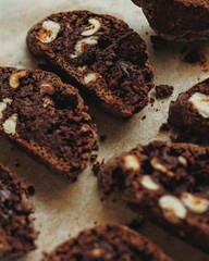 Chocolate chip cookies close-up with hazelnuts . Chocolate cookies with nuts on craft paper. Chocolate cantuccine with crumb. Chocolate rusks. Cutaway cookies. Chocolate chip cookies in a row. 