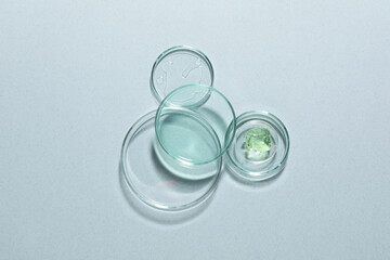 Organic cosmetic product and laboratory glassware on light background, flat lay