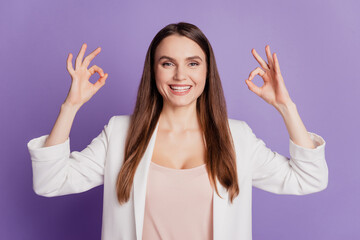 Close up portrait of lady show two okey signs wear formal suit posing on purple wall