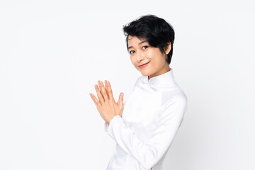 Young Vietnamese woman with short hair wearing a traditional dress over isolated white background...