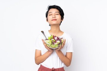 Young Vietnamese woman with short hair holding a salad over isolated background