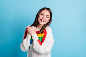 Photo of pretty positive girl folded arms palms toothy smile wear sweater isolated on blue color background