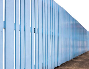 Side view, old wooden fence painted in beautiful blue color.