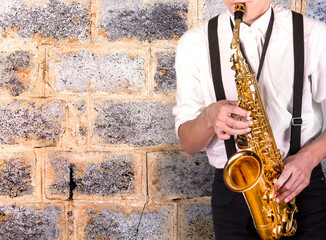 Elegant young man in a white shirt with sax