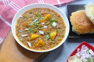 Indian famous dish Mutton Kheema Pav or Khima Paav is a minced goat meat curry. Mutton keema cooked with onion, tomatoes, potatoes, green peas along with Indian spices. copy sapce.