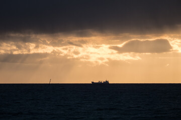 silhouette of a ship in the sunset
