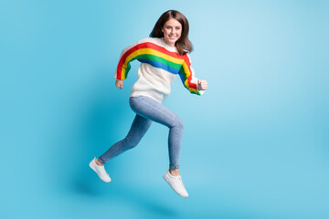 Fototapeta na wymiar Full length body size view of pretty cheerful girl jumping running fast achievement isolated over bright blue color background