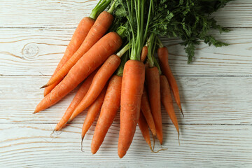 Heap of fresh carrot on white wooden table
