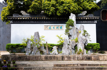 Beautiful Rockery mimicking mountains and cliffs with bonsai at historic Diaohua Building in Dongshan town, Suzhou, Jiangsu, China.