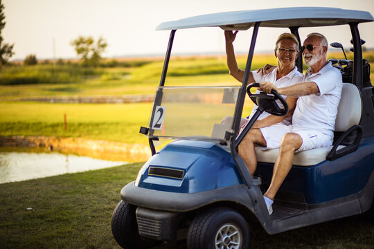 Senior golf's couple in golf car.