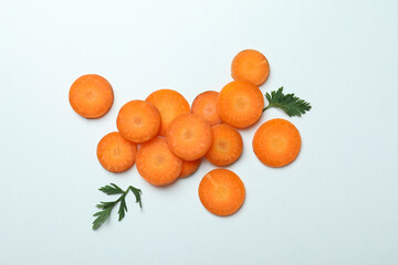 Carrot slices and leaves on white background