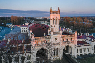 Obraz premium Panoramic aerial view of the New Peterhof railway station in the Pseudo-Gothic style. The western facade of the building is in the form of a four-tiered tower. Russia, Peterhof, 20.10.2020.