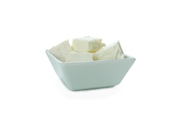 Bowl with feta cheese pieces isolated on white background