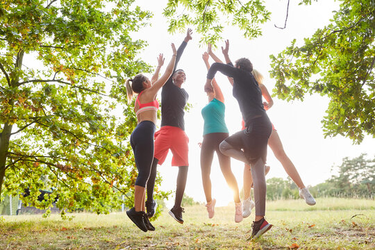 Group Of Friends Giving High Five For Team Building