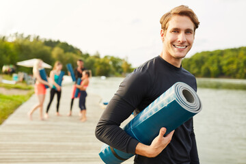 Smiling young man as a yoga instructor