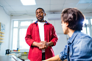 african american student having class with arabian teacher indoors