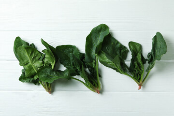 Fresh raw spinach on white wooden background