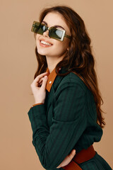 Fototapeta premium fashionable woman in suit modern style sunglasses beige background