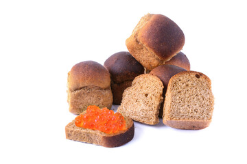 Rye bread buns, whole and sliced with red caviar, isolated on white background, selective focus.