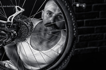 vintage portrait of a mustachioed man repairing a bicycle wheel, eccentric hipster