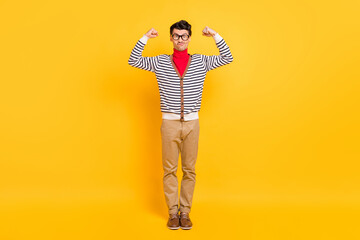 Fototapeta premium Full length photo of young guy sportive show hands muscles biceps triceps isolated over yellow color background