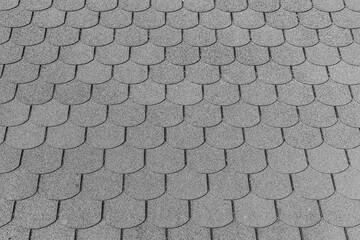 Closeup detail of black bitumen shingles on a roof