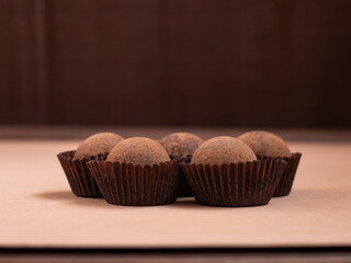 round candy sprinkled with cocoa brown background.