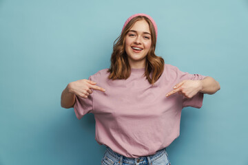 Young happy woman smiling and pointing fingers at herself