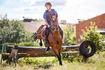 Rolgordijnen Rider jumps horse over log on cross-country course © skumer