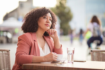 Woman drinking coffee on the street.
