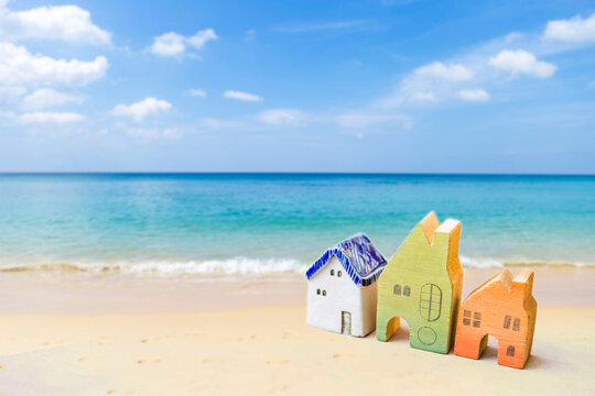 Colorful miniature house on the beach, summer vacation house, accommodation beach front, summer holiday hotel booking
