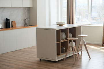 Kitchen in the style of minimalism in white. High countertop with bar stools. A light room in the style of a loft.