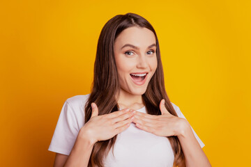 Photo of excited astonished lady palms chest open mouth wear white t-shirt posing on yellow background