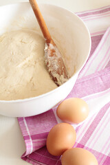 bread backing, fresh dough with eggs on pink towel