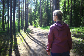 spring forest female windbreaker trekking, springtime rest nature landscape background woman tourist © kichigin19
