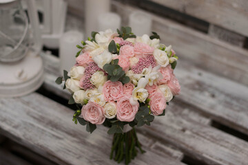 Pink wedding bouquet, composed of roses, freesias, and eucalypthus.
