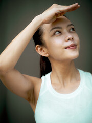 Beautiful young Asian woman doing face yoga poses