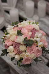 Pink wedding bouquet, composed of roses, freesias, and eucalypthus.
