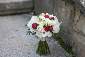 Beautiful bridal bouquet of red roses and white freesia.