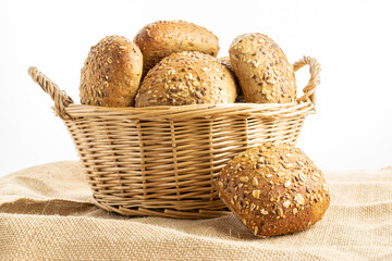 Delicious bread. Fresh loaf of rustic traditional bread with wheat grain ear or spike plant on linen texture background. Rye bakery with crusty loaves and crumbs. Homemade baking.