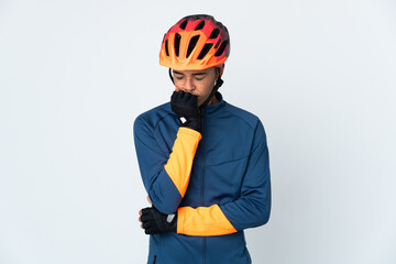 Young cyclist Brazilian man isolated on white background having doubts