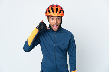 Young cyclist Brazilian man isolated on white background making phone gesture. Call me back sign