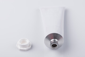 Top view of open blank cosmetic tube isolated on white