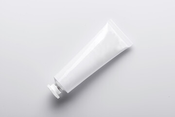 Top view of open blank cosmetic tube isolated on white